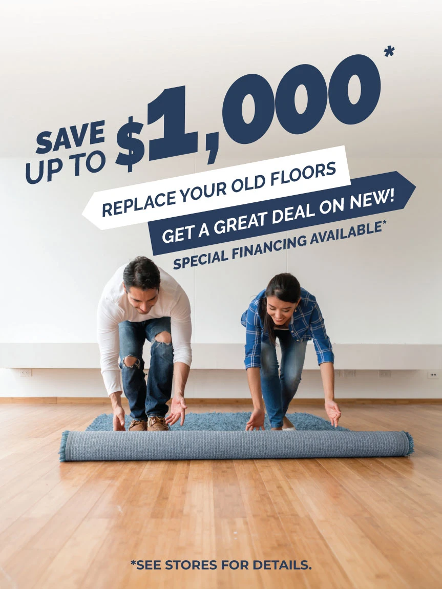 Couple rolling carpet on the floor by Buddy's Flooring America